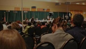 Picture of convention crowd facing podium.